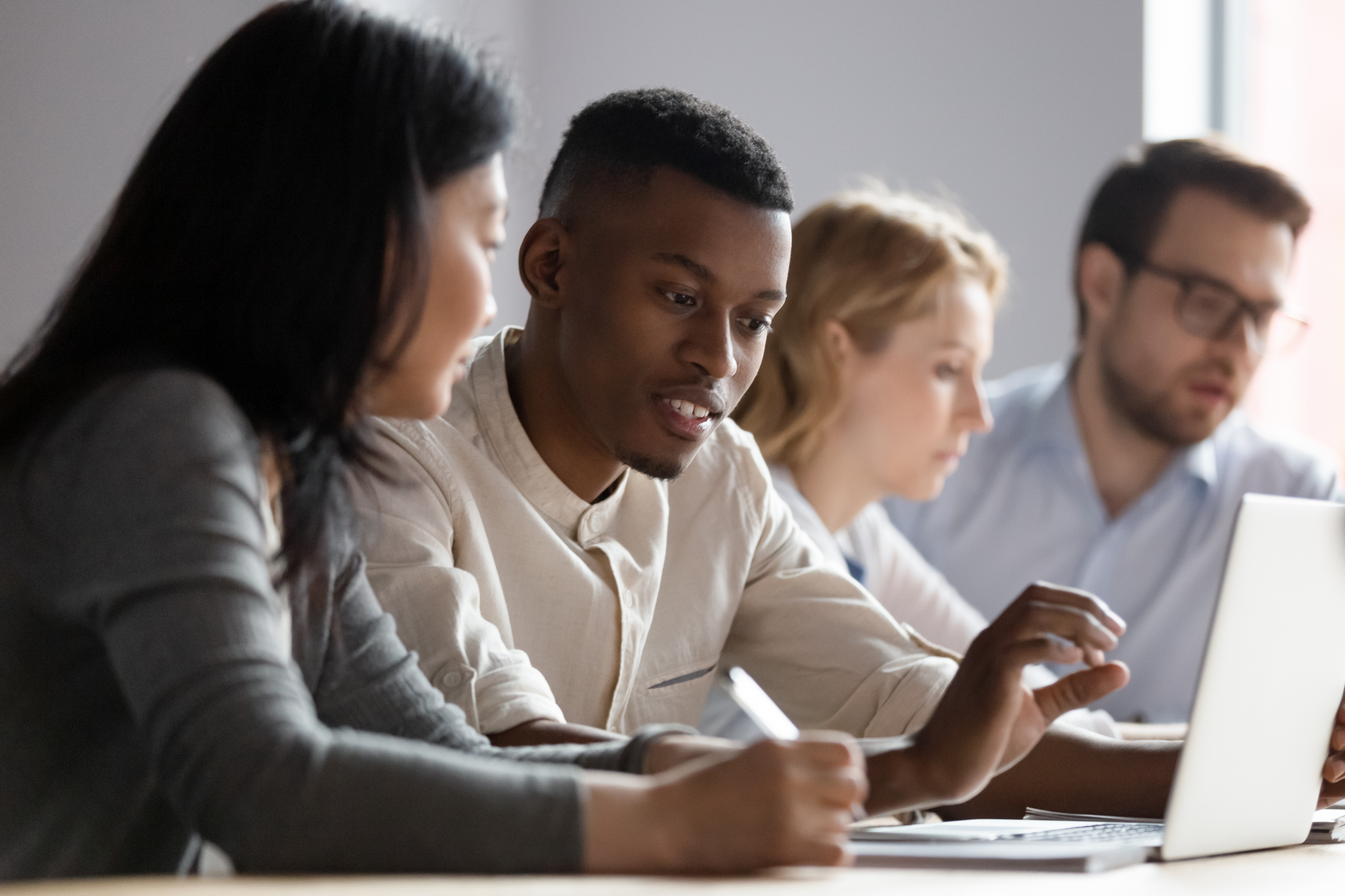 Group of people collaborating in a peer mentoring session